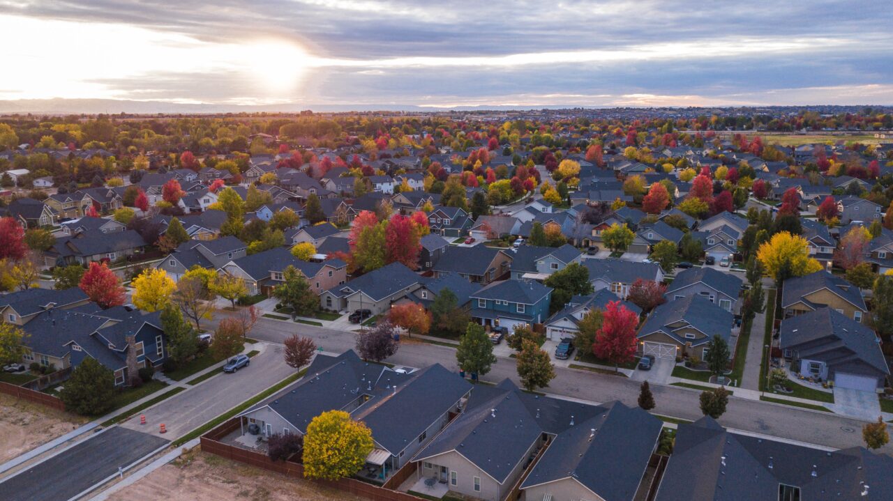 neighborhood in fall with trees of red yellow and orange